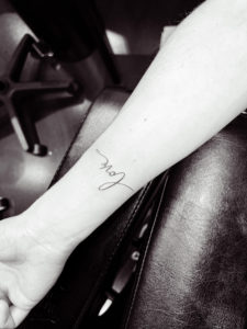 tiny tattoo of love written in cursive, permanent makeup in Raleigh, permanent makeup in Raleigh